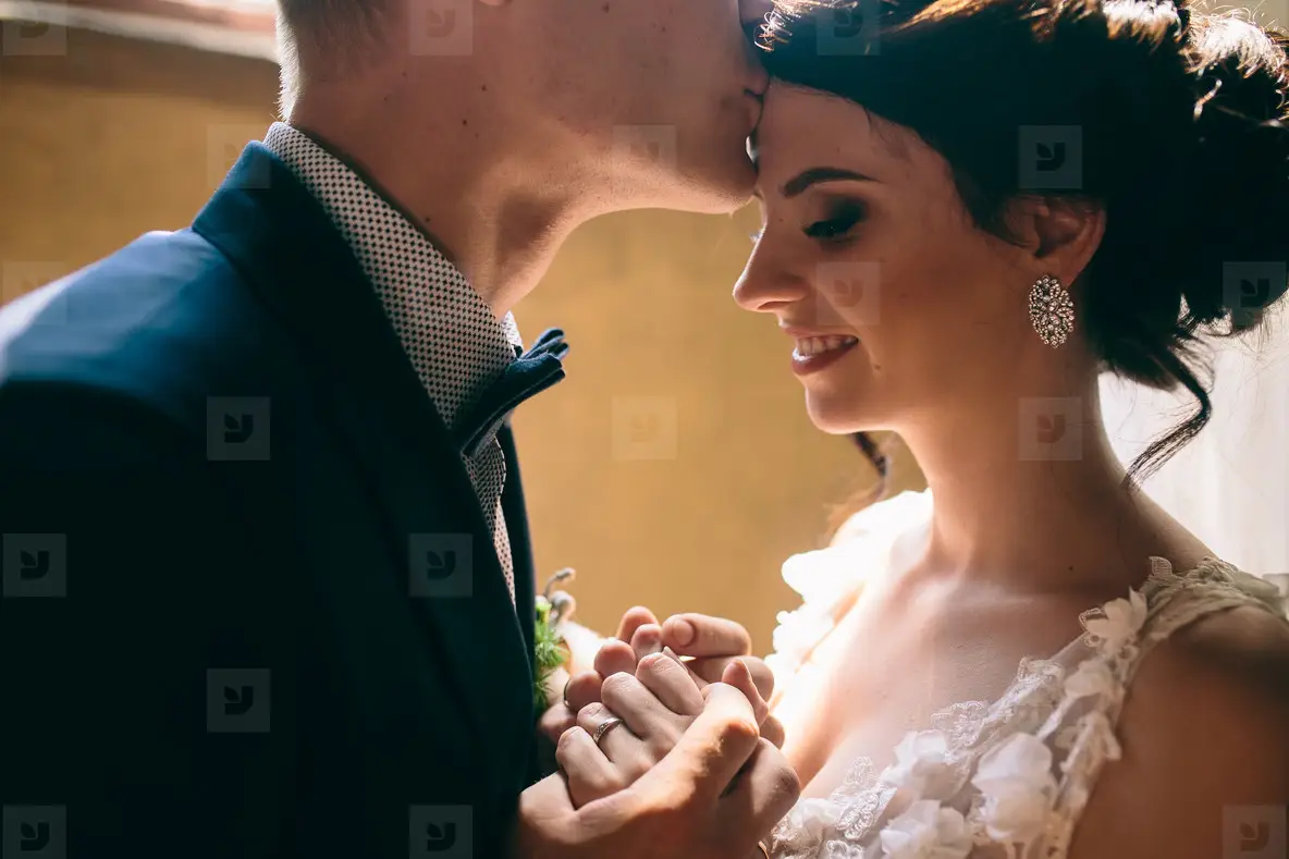 bride and groom on the background of a window
