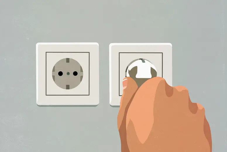 Hand plugging cord into electrical outlet