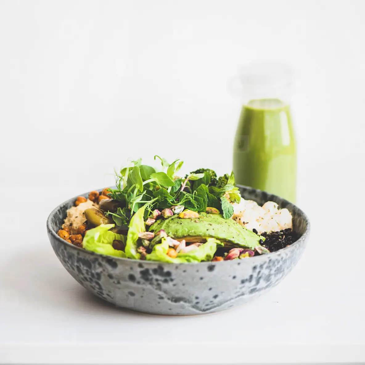 Healthy vegan superbowl with vegetables and green smoothie  square crop