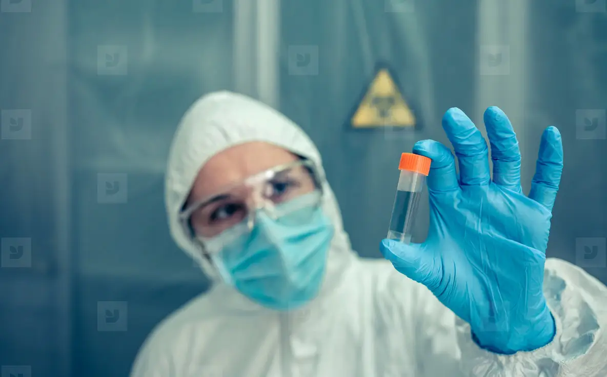 Scientist With Protection Suit Looking Vial In The Laboratory Photo ...