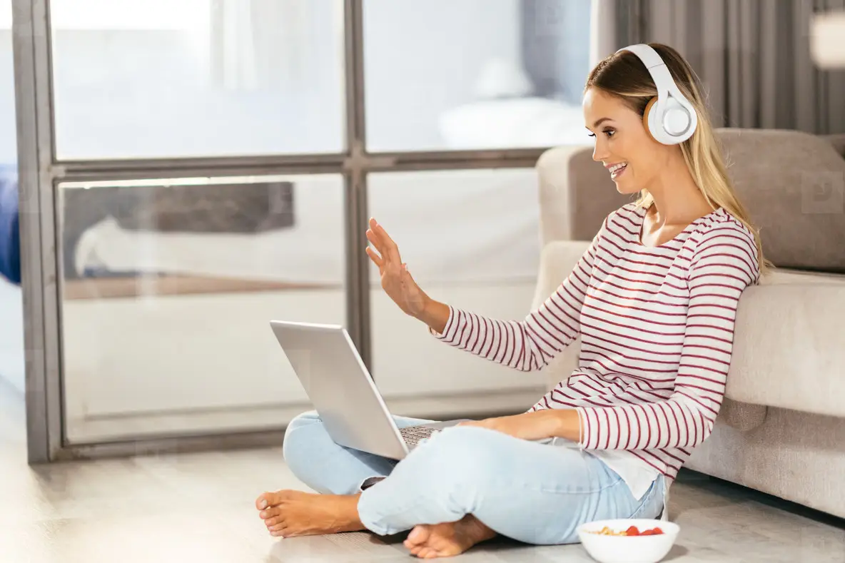 Smiling Young Woman With Headphones And Laptop On The Sofa Photo ...