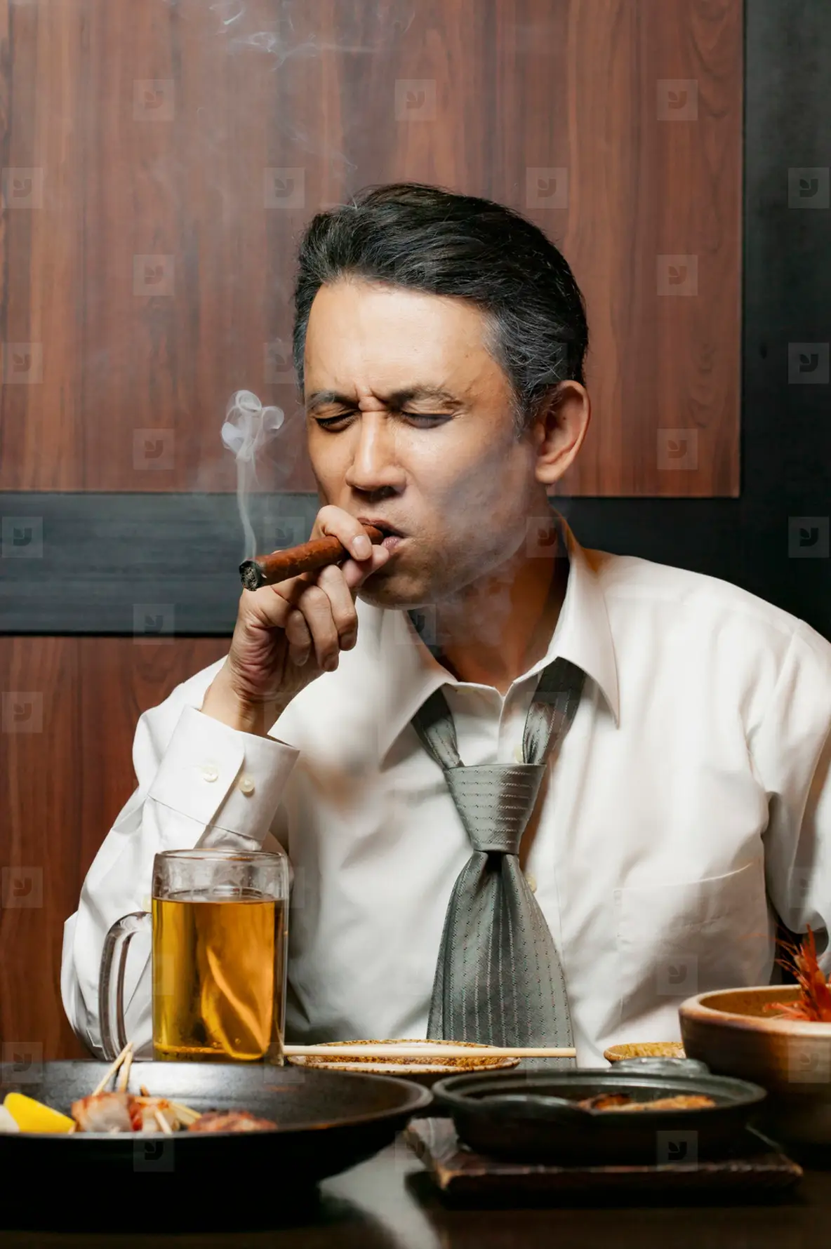 Businessman Smoking Cigar At Lunch In Restaurant Photo (233346)