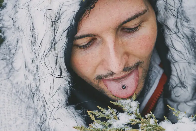 Young man enjoying a snowy day in a forest