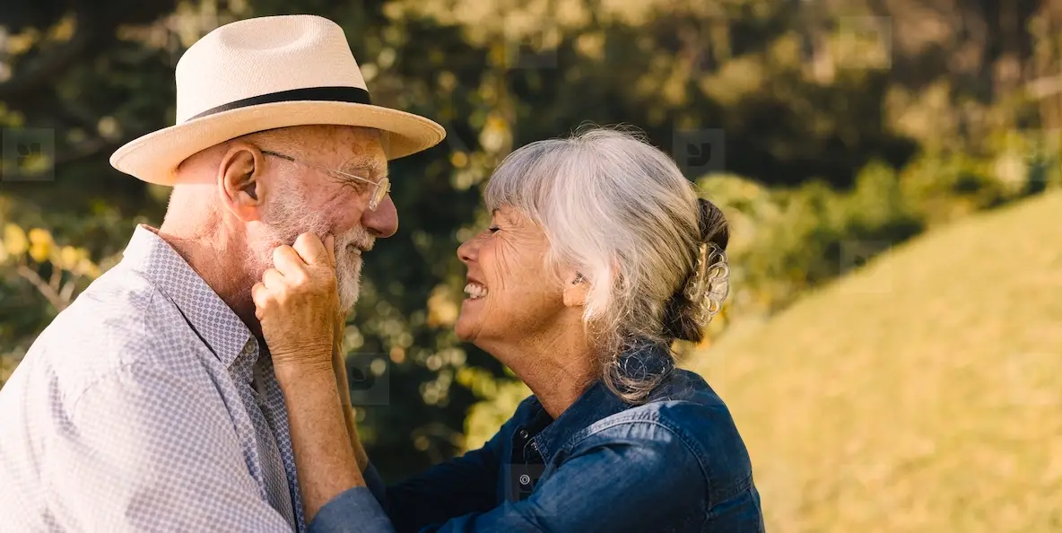 Elderly Couple Smiling At Each Other And Expressing Their Love Photo ...