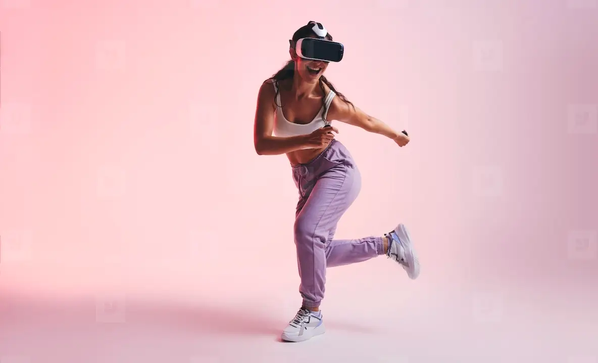 Happy young woman enjoying a virtual reality experience in a studio