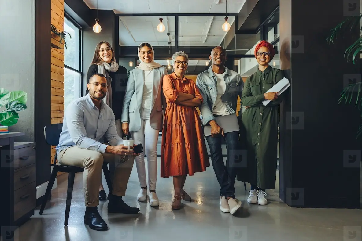 Multicultural business team smiling at the camera in an office