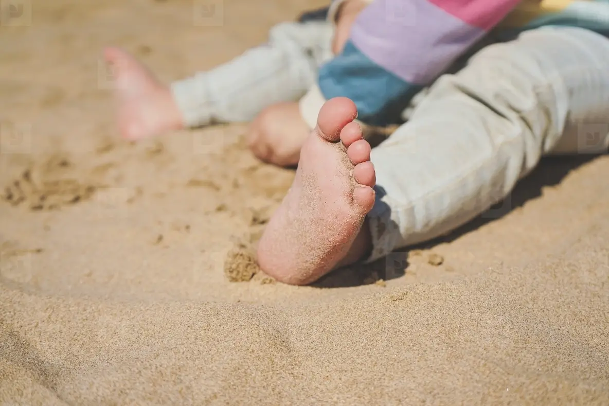 Close Up Of The Feet Of A Toddler With Sand Of The Beach Photo