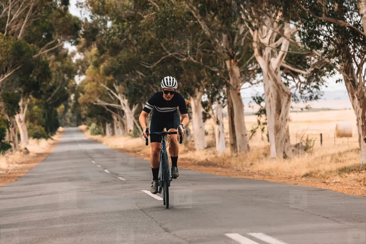 Professional cyclist practicing on a long empty road