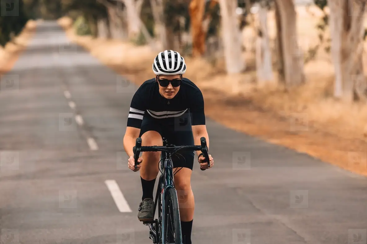 Pro Bike Female Rider Wearing Helmet And Sunglasses Training