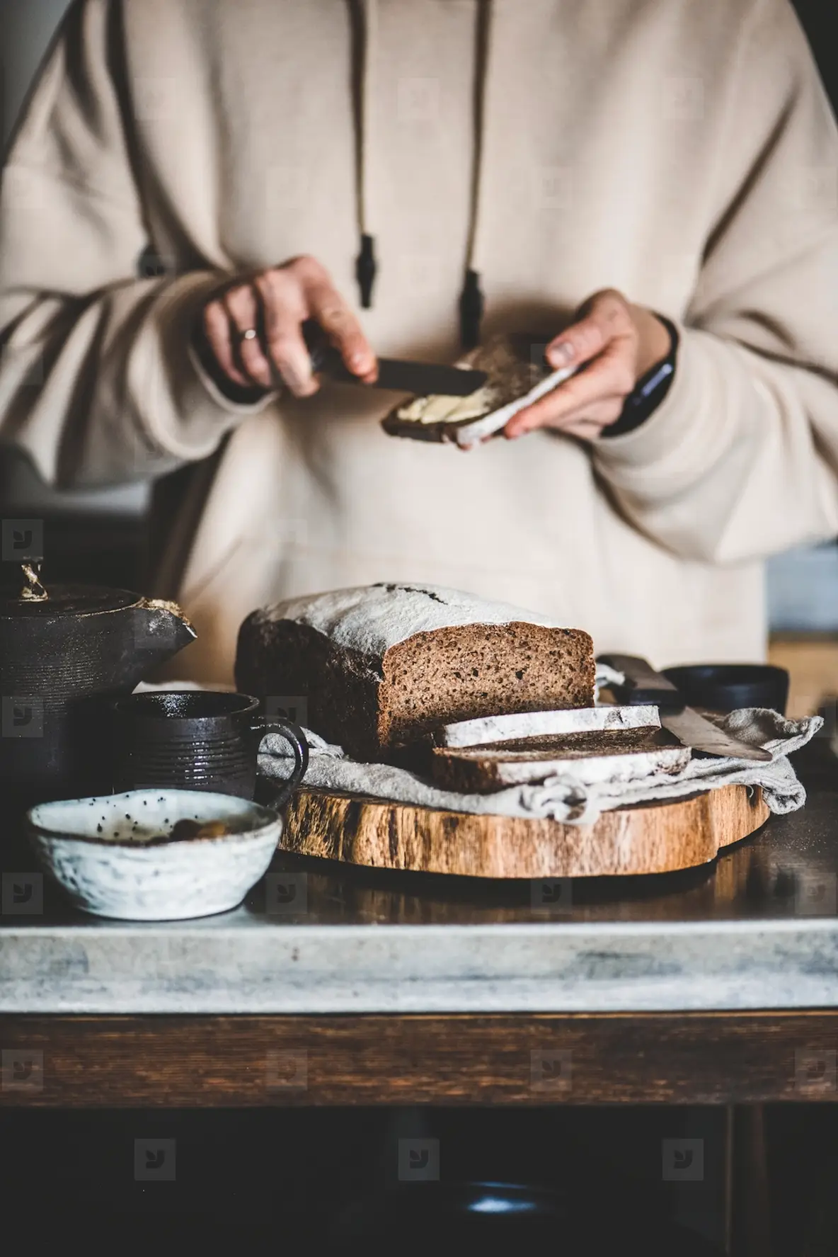 Woman having breakfast with rye Swedish bread and butter