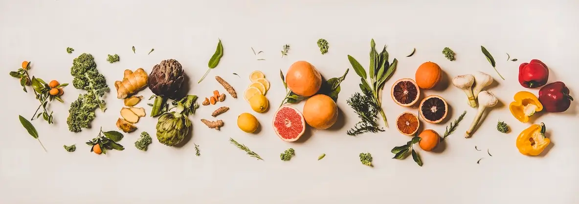 Variety of colorful immunity boosting plant foods over white background