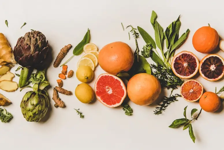 Variety of immunity boosting healthy plant foods over white background