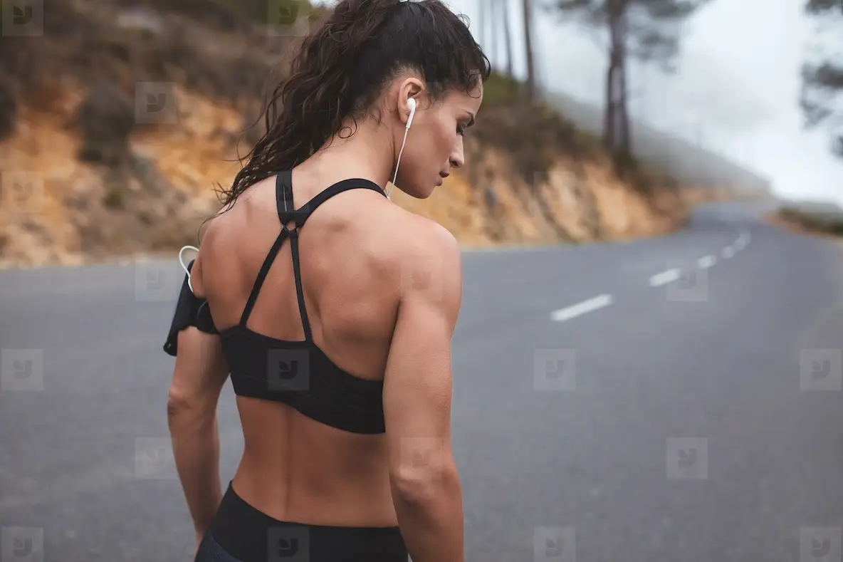 Female Athlete With Muscular Body Standing On A Country Road Photo