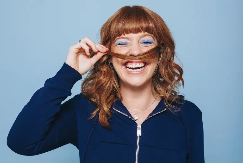 Playful woman making a moustache with her hair