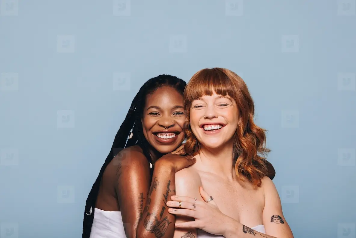 Two Women With Different Skin Tones Standing Together In A Studio Photo ...