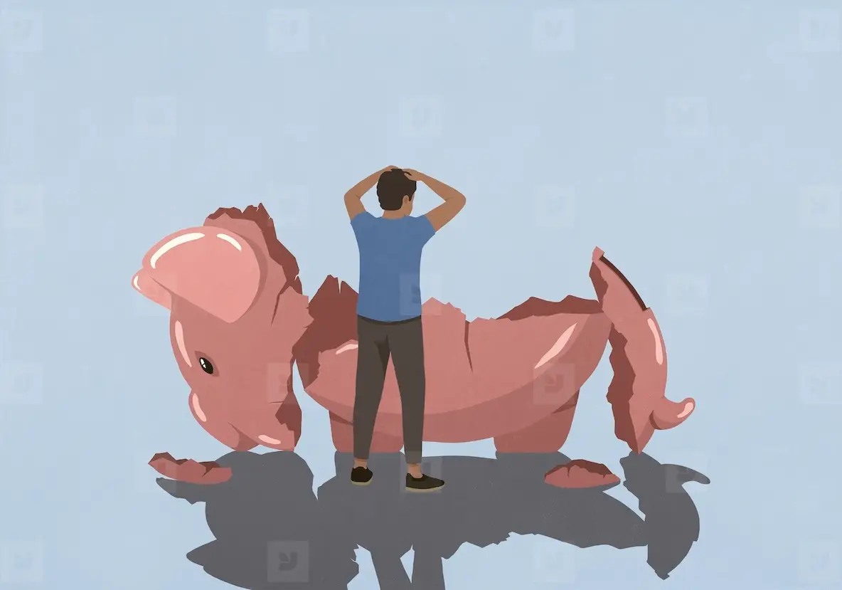 Stressed man looking at broken piggy bank