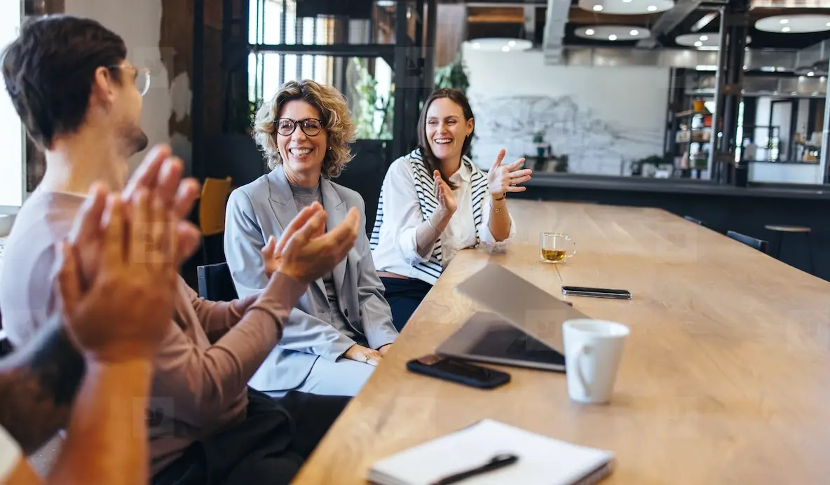 Happy Business People Applauding During A Meeting In An Office Photo ...