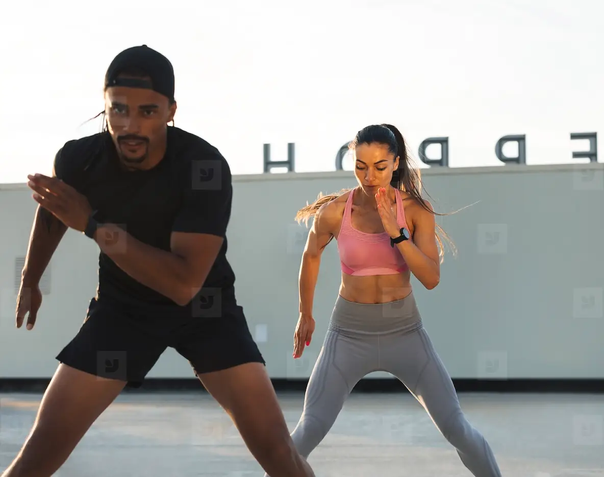Man And Woman Are Warming Up Before Training On A Fitness