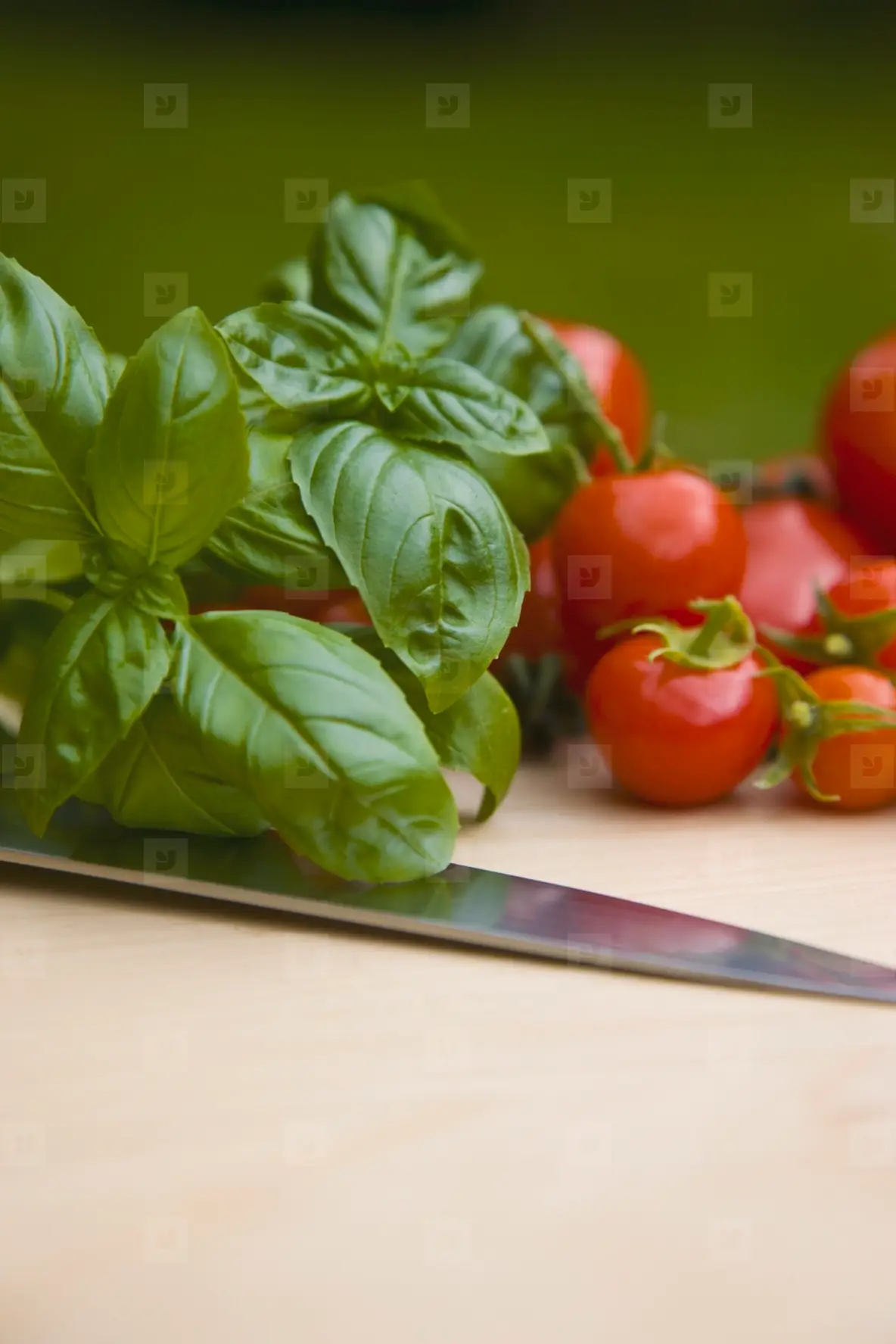 Close Up Of Cherry Tomatoes Basil Leaves And A Knife Blade Photo ...