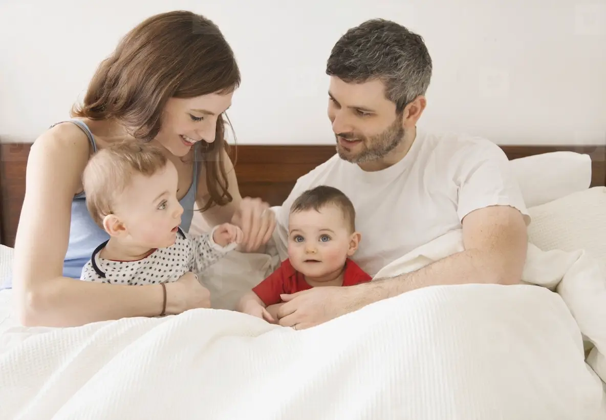 Couple In Bed With Baby Twins Photo (282502) - YouWorkForThem