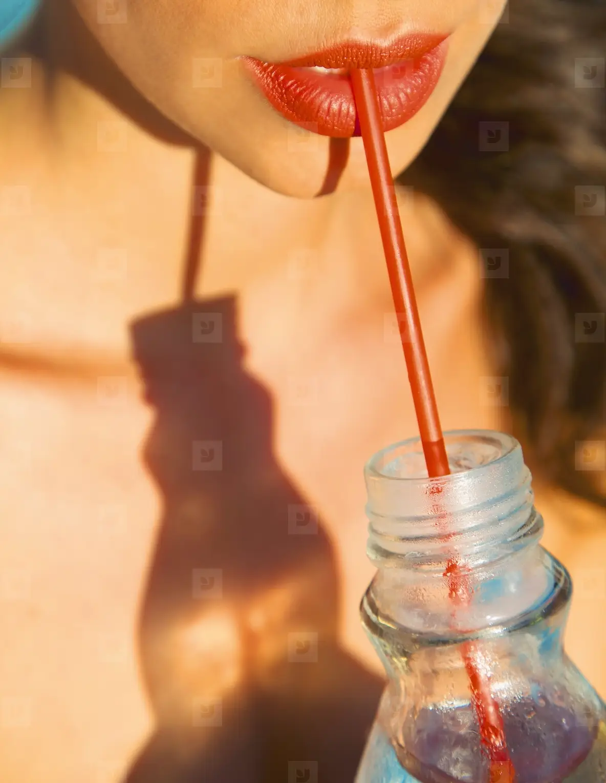 Close up of Woman s Mouth Drinking with Straw