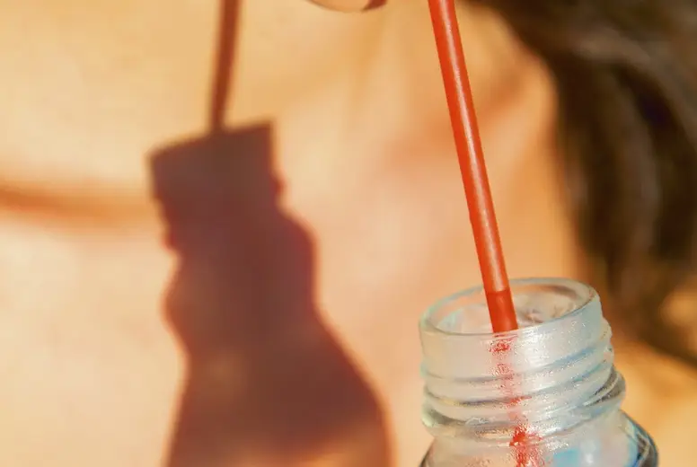 Close up of Woman's Mouth Drinking with Straw