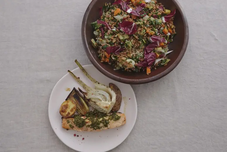 Still life view from above gourmet grilled salmon and leeks, and spelt salad with radicchio