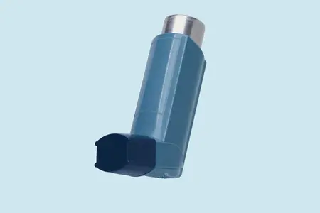 Close up still life of blue inhaler on blue background