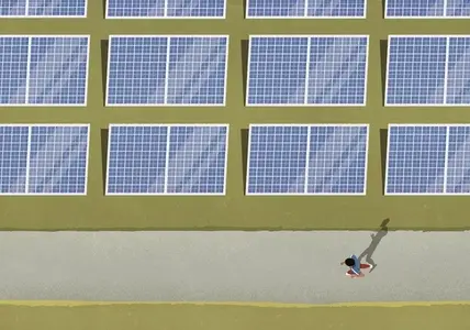 View from above man jogging along solar panels in field