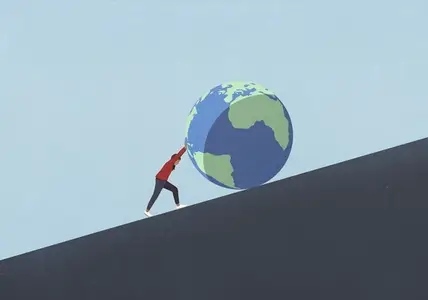 Woman pushing large globe uphill