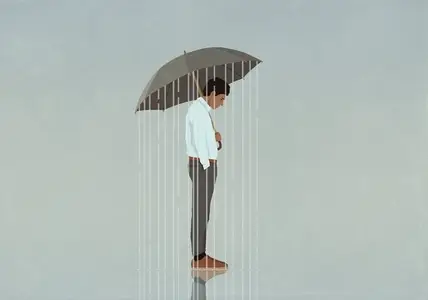 Rain falling from umbrella over depressed man