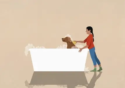 Girl giving dog bubble bath