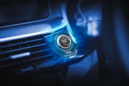 The car start button glows to indicate that it is ready to start