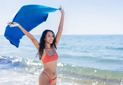 Experience a Joyful Beach Moment with a Flowing Silk Shawl and Vibrant Surroundings