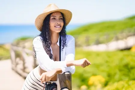 Cheerful Young Woman Enjoying a Wonderful Summer Day at the Beautiful Beach Setting