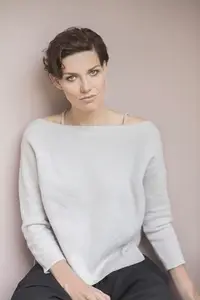 Studio portrait of beautiful woman with short brown hair wearing off shoulder sweater
