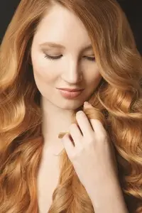 Close up portrait of beautiful young woman with hand in long