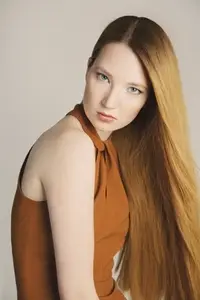 Studio portrait of beautiful serious young woman with long
