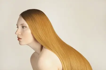 Side view portrait of beautiful serene young woman with long