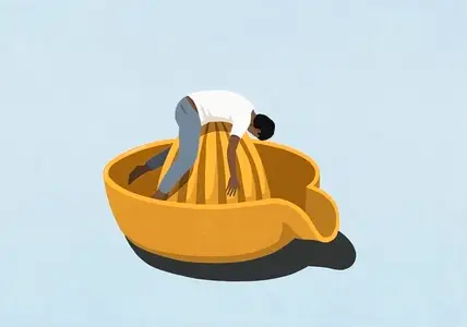 Man laying on top of large yellow citrus juicer against blue background