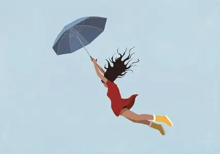 Woman with arms raised holding umbrella