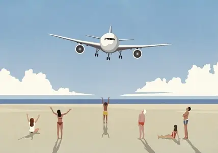 Tourists on sunny summer ocean beach waving at low flying airplane