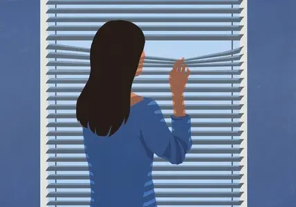 Suspicious woman standing at window