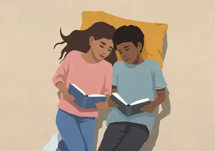 View from above of affectionate mother and son reading books on pillow