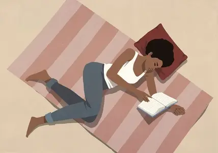 View from above of woman relaxing laying on floor and reading book