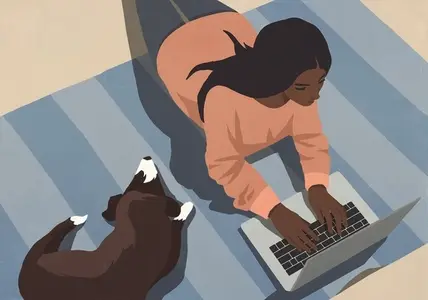 High angle view of woman working at laptop on floor next to sleeping dog