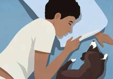 View from above of tired man sleeping next to dog in bed at night