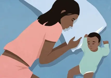 View from above of baby son and mother sleeping side by side in bed
