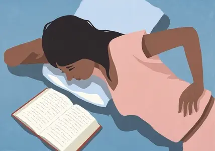 View from above of woman in pajamas relaxing in bed