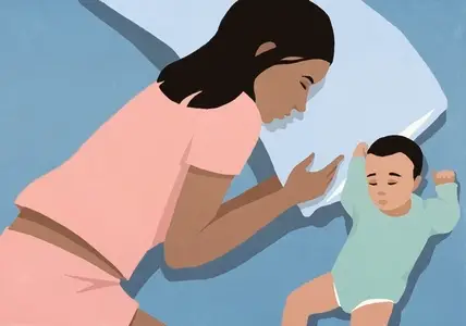 View from above of mother and newborn baby boy sleeping side by side in bed